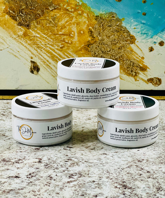 Three containers of Lavish Body Cream by The Jo 'Marie Collection, displayed on a surface with a colorful artwork background.