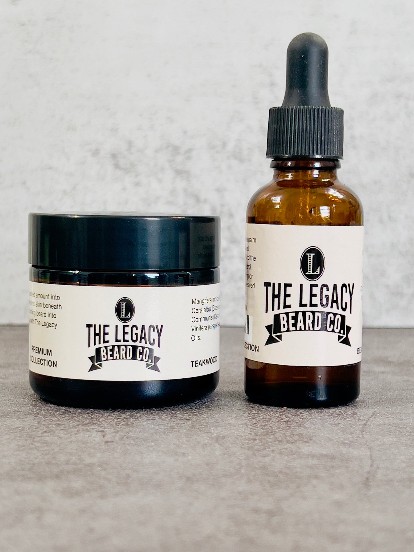 A jar of beard butter and a bottle of beard oil with labels, on a grey background.