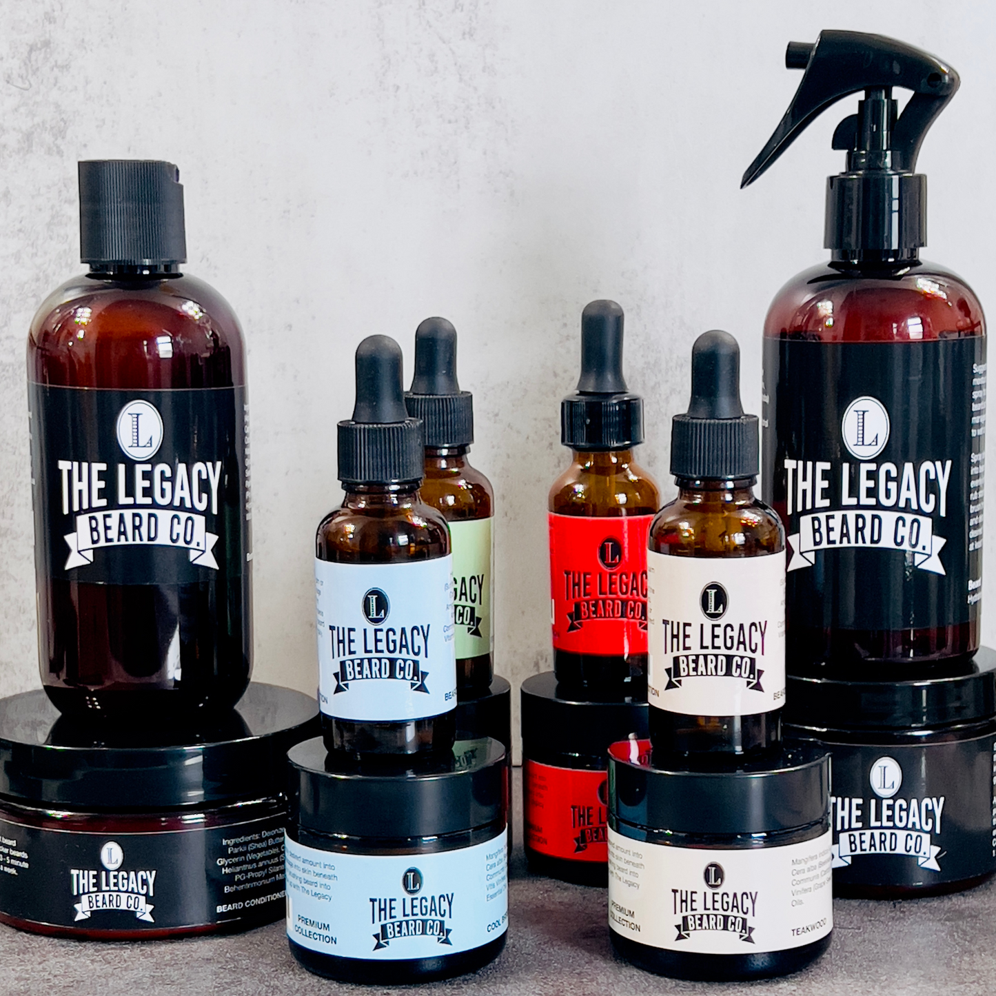 A collection of beard care products from The Legacy Beard Co., including bottles of beard wash, conditioner, hydration mist, softener, beard butter, and oil.