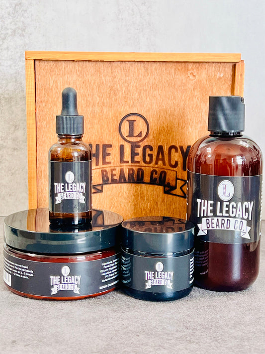 Beard kit wil a white background on a concrete surface. This Kit includes:8 oz. Beard Wash, 8 oz., Beard Conditioner, 3 oz. Beard Enhancer, 1 oz. Beard Oil, Wood keepsake box