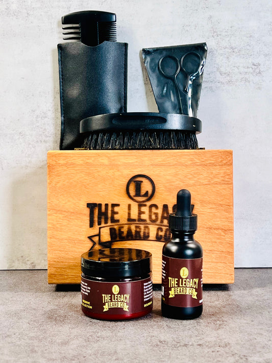 Set of grooming products with 'The Legacy Beard’ branding on a wooden box. Beard Kit Package includes a Beard Oil 1 FL. OZ,
Beard Enhancer 3 FL. OZ, Boar Bristle Beard Brush, Wooden Beard Comb, Stainless Steel Scissors, and Keepsake Wooden Box.