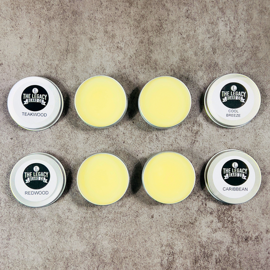 Set of eight tins with different scents on a textured surface