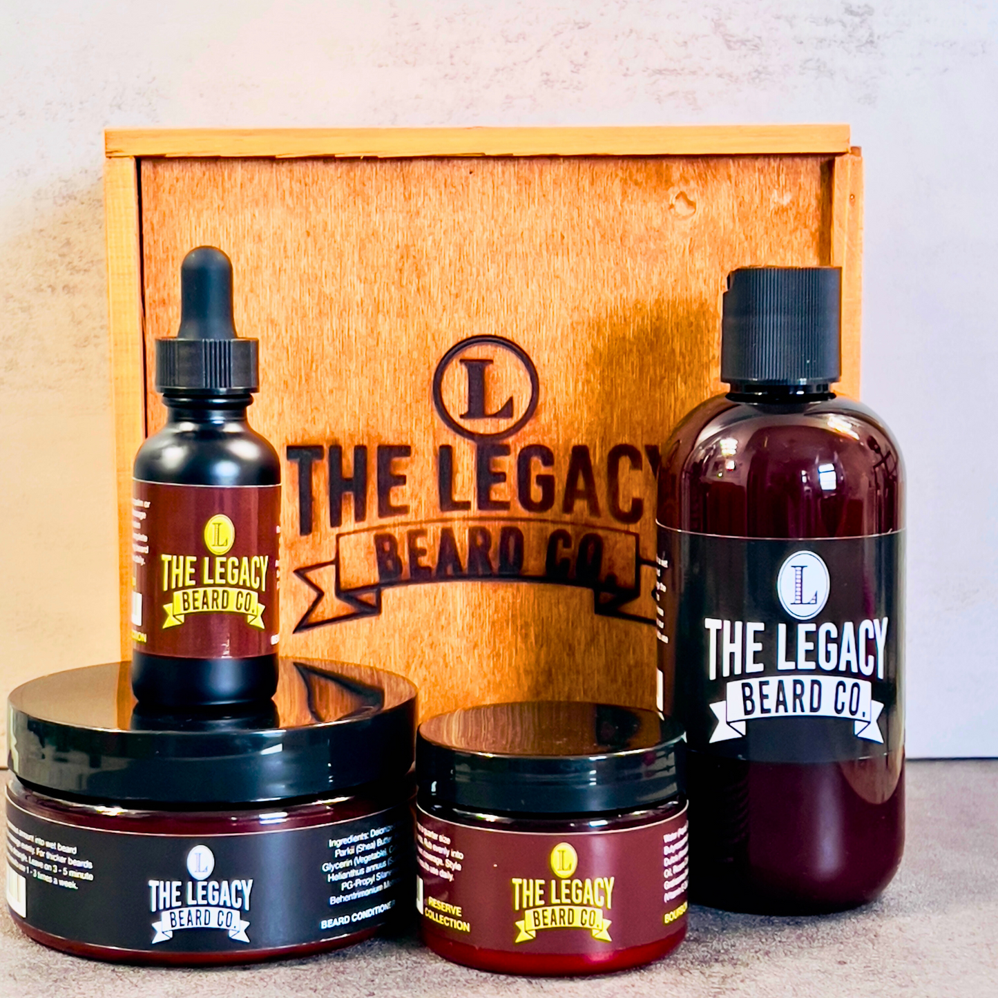 Beard kit wil a white background on a concrete surface. This Kit includes:8 oz. Beard Wash, 8 oz., Beard Conditioner, 3 oz. Beard Enhancer, 1 oz. Beard Oil, Wood keepsake box