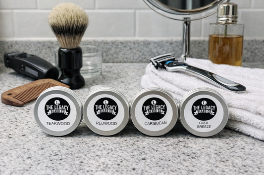 Four containers labeled 'The Legacy Beard Co.' with grooming tools on a bathroom counter.
