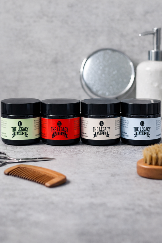 Set of hair care products with 'The Legacy Barber' branding on a gray surface.